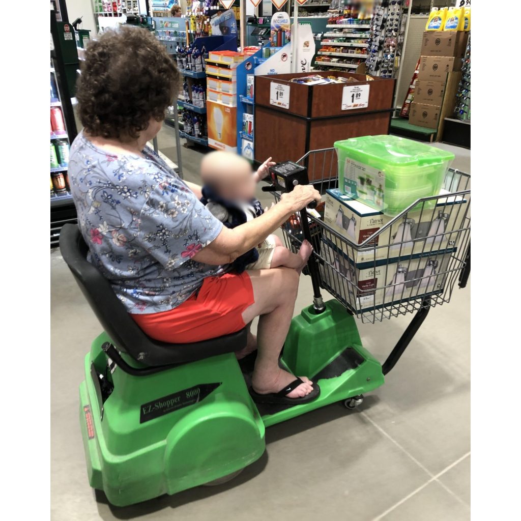 Shopper riding an EZ Shopper 8000 electric cart in a store