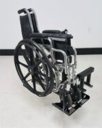 Folded wheelchair loaded on the Tote Model 003 three quarter view
